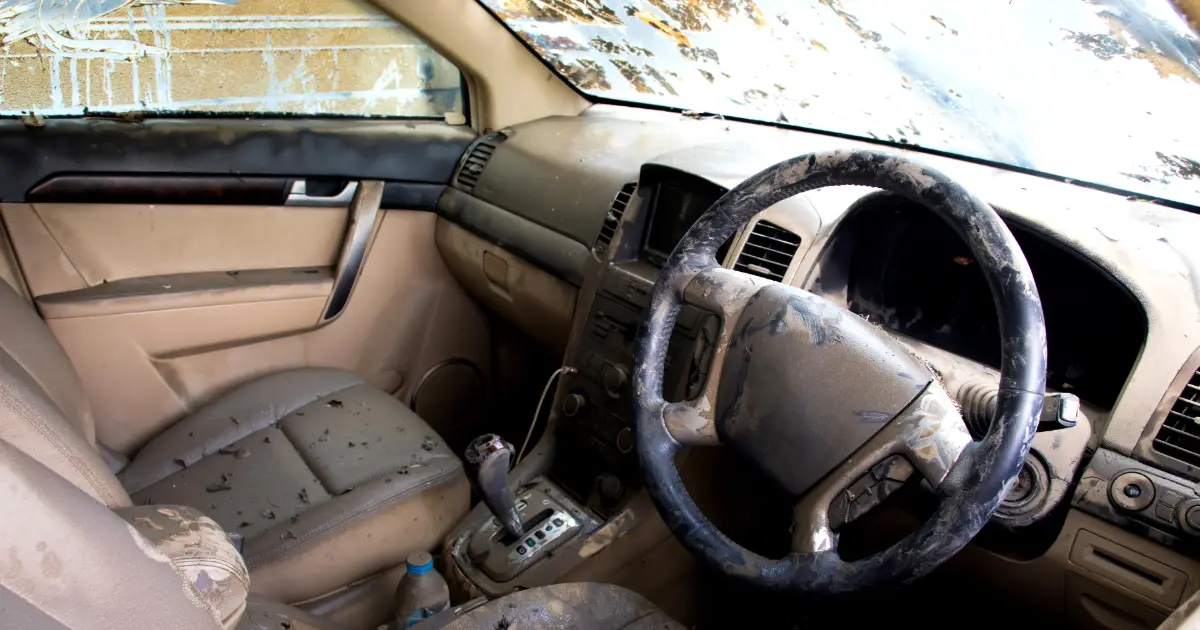 A car interior covered in dust and mold from flood damage — selling a flood-damaged car in Houston, TX