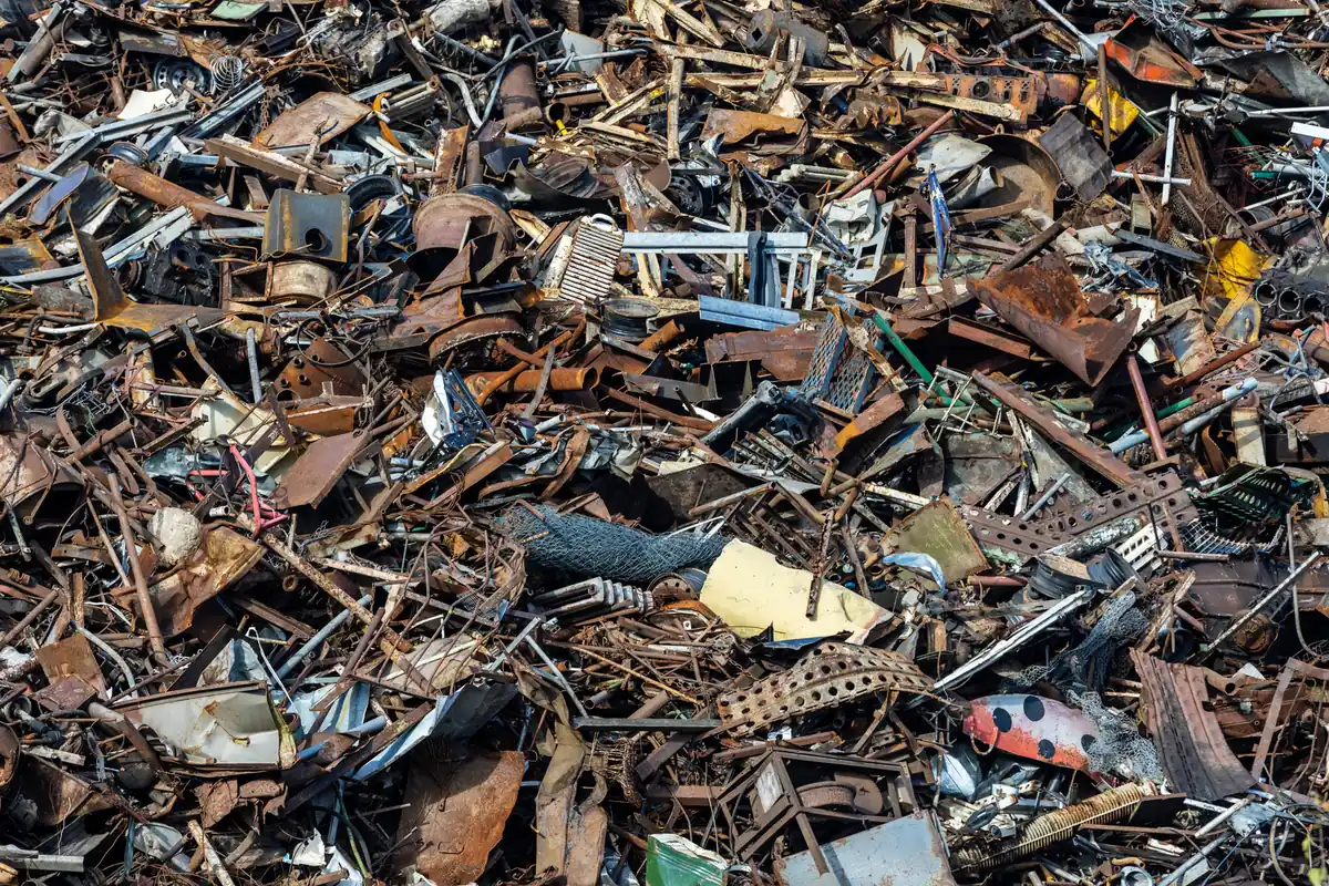 Pile of scrap metal at a recycling yard, where a junk car’s weight sets the floor price