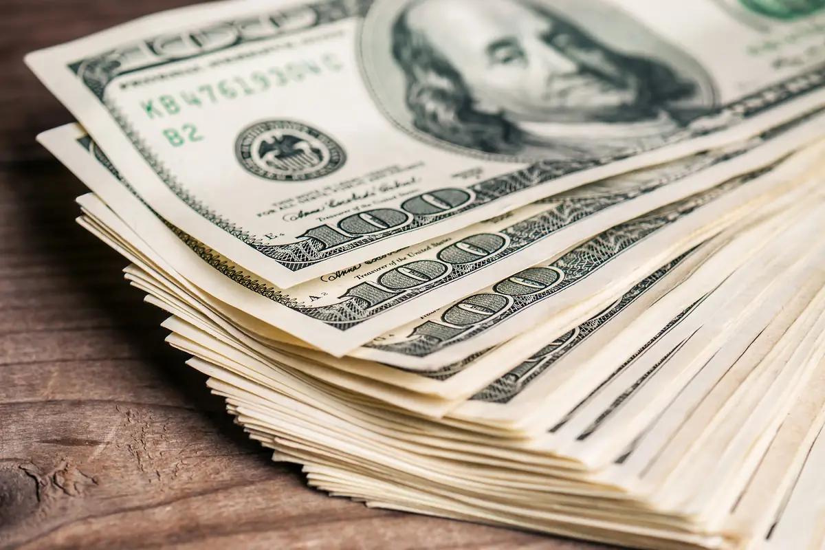 Cash for cars in Texas: stack of us hundred-dollar bills Stack of US hundred-dollar bills, the payout sellers look for with cash for cars in Texas