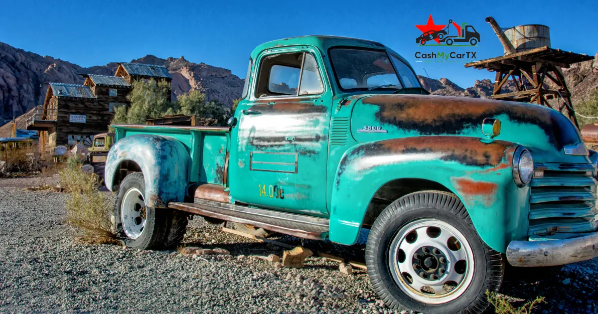A weathered vintage pickup truck parked in the desert — selling an old work truck or fleet vehicle in Texas