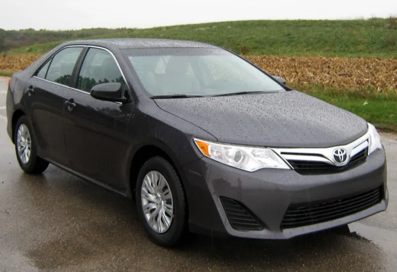 Silver Toyota Camry LE sedan, front three-quarter view — one of the models we buy for cash across Texas